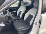 the interior of a white car with two black seats and a steering wheel