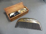two combs and a box on a table