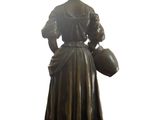 bronze statue of a woman holding a jug of water on a marble base