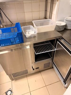 stainless steel counter top in a commercial kitchen with dishes stacked on top of it