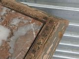 a close up of a wooden frame with a marble top