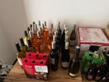 many bottles of wine sitting on a table with a price tag
