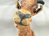 a statue of a giraffe with horns on it ' s head