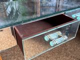 a glass desk with a drawer underneath it