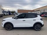 a white suv parked in a parking lot next to a building