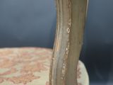 a close up of a chair with peeling paint on it