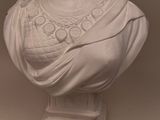 marble bust of a woman wearing a headdress and a shawl