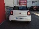 a small white car parked on the side of the street
