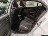 a white car with the door open and the passenger seat down