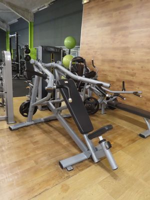 gym equipment in a gym with a wooden floor and a wooden wall