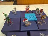 many figurines of different sizes and colors on the table