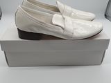 pair of white shoes on a white box on a white surface