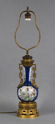 an image of a blue and gold vase lamp on a table