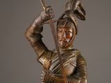 a bronze statue of a man holding a sword