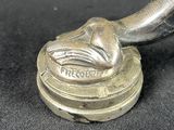an antique silver plated spoon on a black cloth with a silver handle