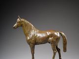 bronze statue of a horse on a wooden base