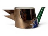 a metal teapot with a blue flower on it