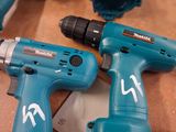 several electric tools are laying on top of a wooden table