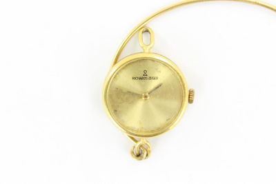 une image d'un gros plan d'une montre-bracelet sur une surface blanche