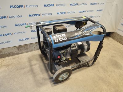 the generator is sitting on the floor in front of the wall