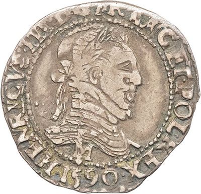 a silver coin with an image of a man wearing a headdress