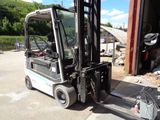a fork lift truck parked in front of a building