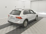 the back end of a white volkswagen suv parked in a garage