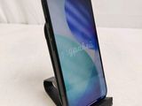 a phone that is sitting on a stand on a bed