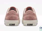 the shoes are pink and white with black lettering on them