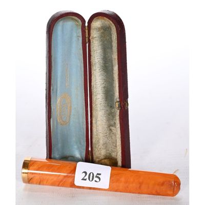 a wooden case with a pen in it on a white surface