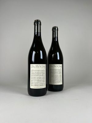 two bottles of wine sitting next to each other on a table