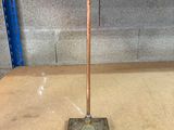 a metal pole that is on the floor in a room