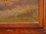 a painting on the wall of a room with a wooden frame