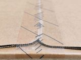 a close up of a cardboard box with a chain on it