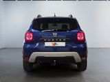 the rear end of a blue car parked in a showroom