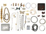 many different types of jewelry on a white surface