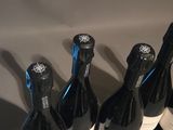 three bottles of wine are lined up on a table