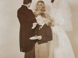 a vintage photo of a bride and groom feeding each other a piece of cake