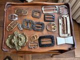 a wooden tray with many different types of belts and buckles