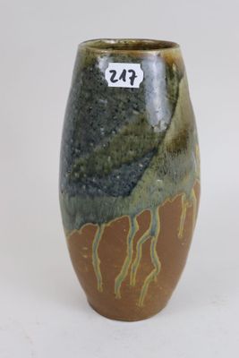 a brown and green vase with a number on it