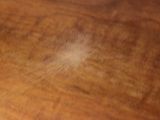 a blurry photo of a wooden table with a cell phone on it