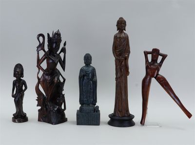 several wooden statues of different shapes and sizes on a white surface