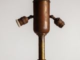 an old fashioned lamp that is on top of a table