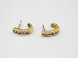a pair of gold earrings with black diamonds