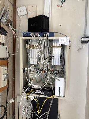 a bunch of wires on a shelf in a room
