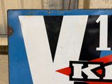 a blue and white sign with a red and black v on it