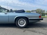 an image of a blue convertible car parked in a parking lot