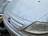 a silver van that is parked on the side of the road