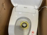 a toilet that is sitting in a box with the lid up