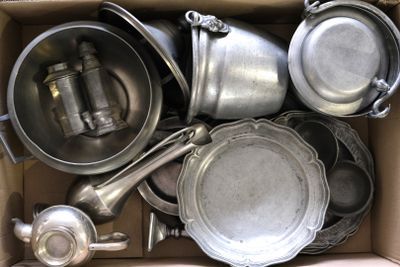 a cardboard box filled with many different types of pots and pans